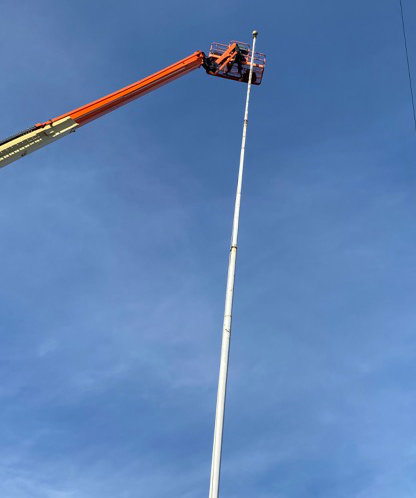 Using a lift, a painter from A & A Industrial gave a fresh coat of paint to the landmark flagpole in the hamlet of Marlboro last Sunday.